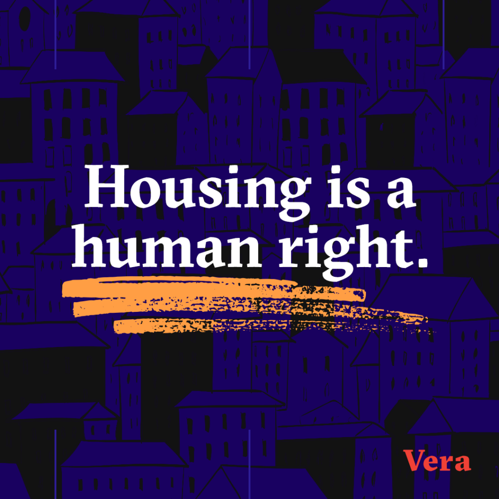 Housing is a human right. Dark blue houses and buildings on a black background.